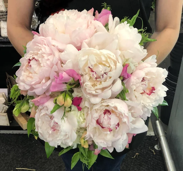 A wide shot of the MJ Liquidation store interior showcasing a vast selection of discounted products neatly organized in various sections. The image should convey a sense of abundance and choice. Technical specs: 4K resolution, natural lighting